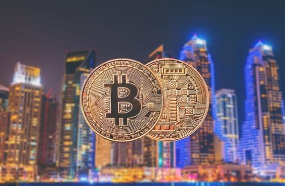 पृष्ठभूमि में गगनचुंबी इमारतों के साथ बिटकॉइन सिक्के।