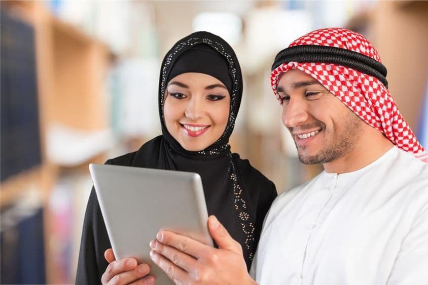 अरबी छात्र टैबलेट पर अध्ययन सामग्री देखते हुए।