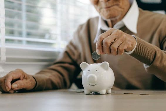 बचत करते हुए व्यक्ति, सिक्के को गुल्लक में डालते हुए